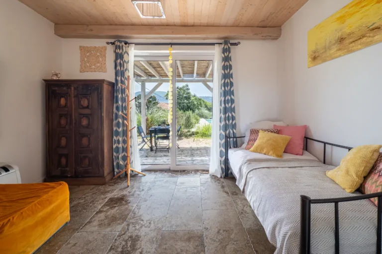 Ganesha room in the main house with single bed and glass doors to the terrace