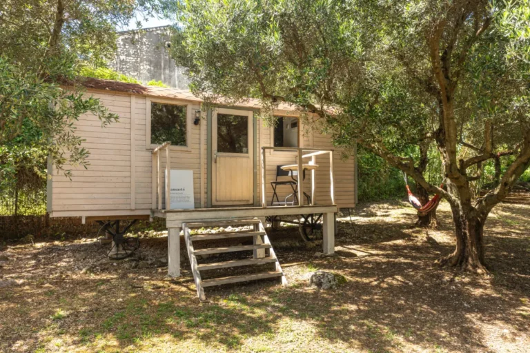 Namaste tiny house at Manto Corfu, a wooden cabin with steps under the trees