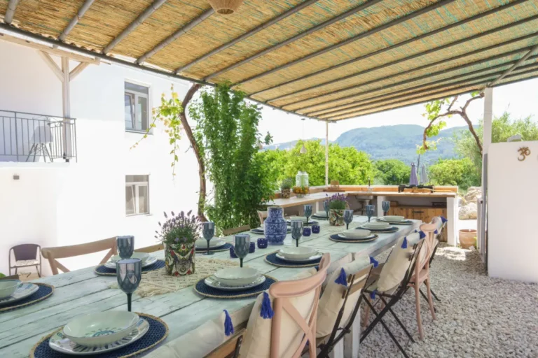 Long table set for dinner on the covered terrace
