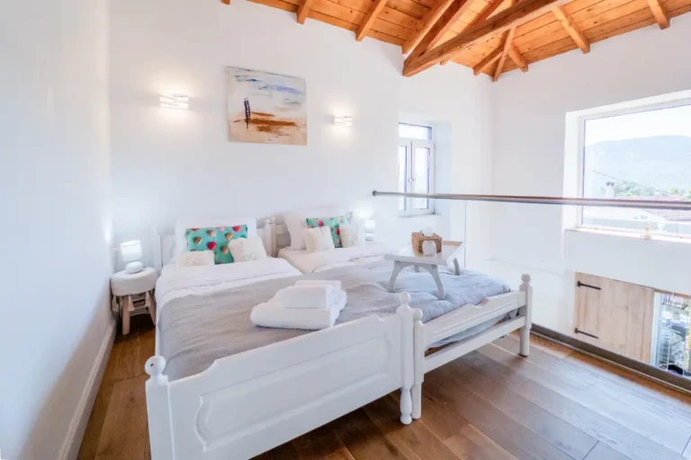 Prana room on the upper floor with two beds and a view of the hills