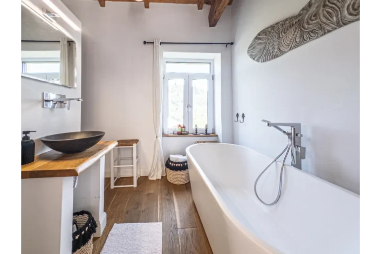 Bathroom with freestanding bathtub and washbasin