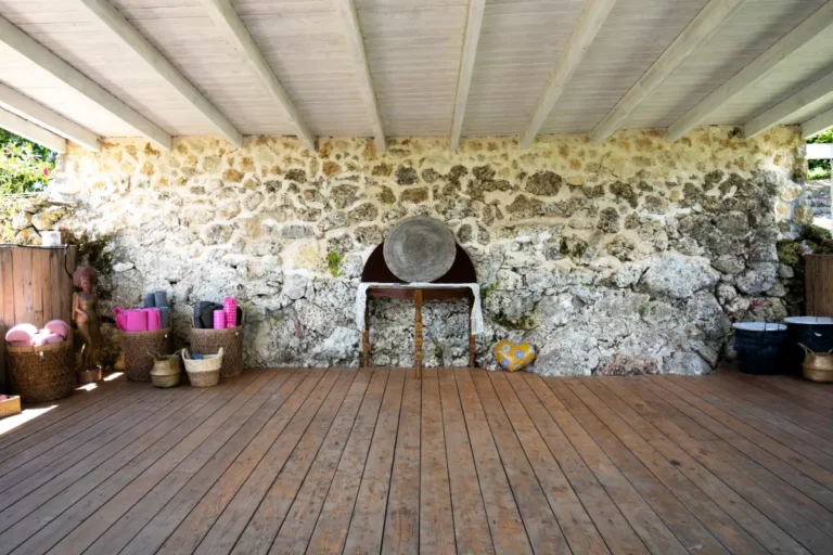 Covered deck with natural stone wall and wooden floor
